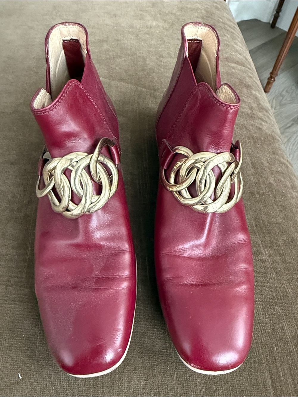 TOD’s Women's Burgundy Leather Ankle Boots with Decorative Gold Chain